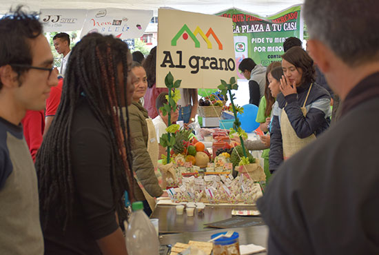 Personas vendiendo sus productos en feria local