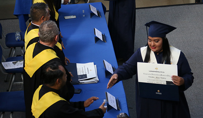 Egresados recibiendo el diploma de UNIMINUTO