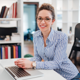 Mujer en escritorio sonriendo
