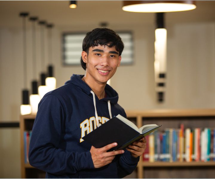estudiante con un libro en una biblioteca estudiante con un libro en una biblioteca