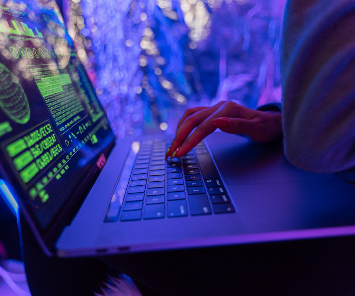 Persona trabajando en un computador visualizando fórmulas y código informático en pantalla, representando el desarrollo tecnológico, la programación y el uso de software libre promovido en el FLISoL 2026 de UNIMINUTO Tolima-Huila.