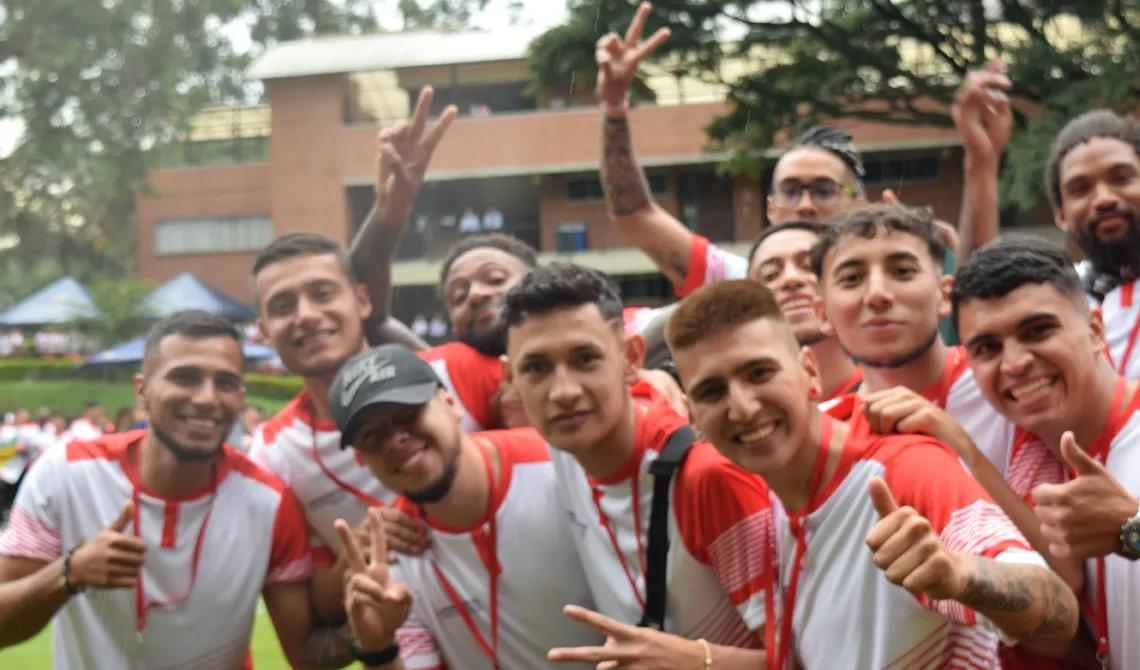 Amigos de la delegación de Bogotá presencial posando alegres para la cámara.