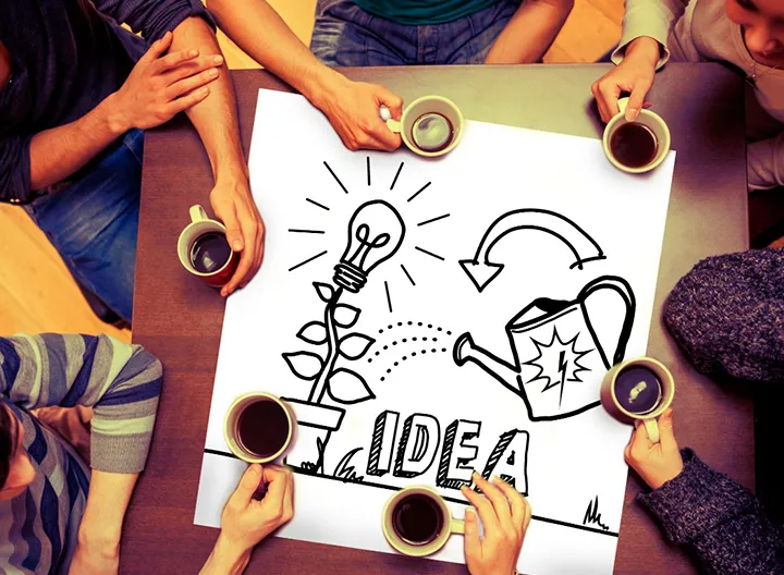 Mesa de trabajo de jóvenes, con ilustración que hace referencia a cosechar ideas