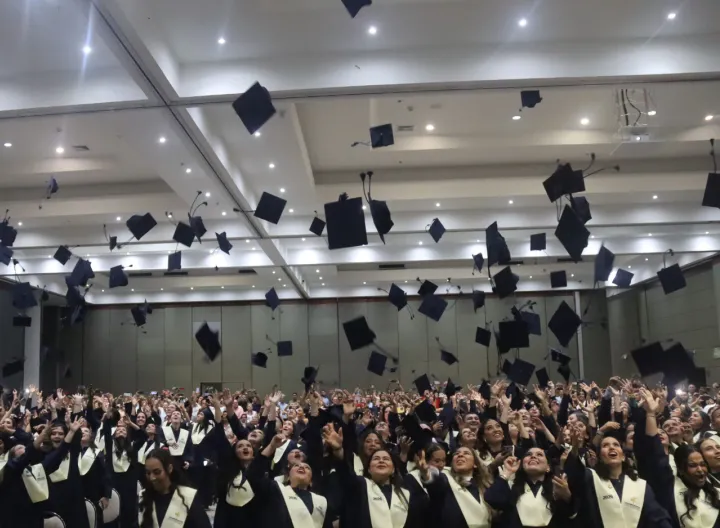 Graduados uniminuto lanzando birrete de grados 