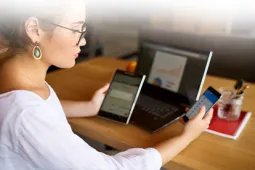 mujer-revisando-celular-y-computador