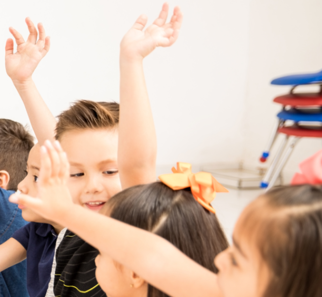Niños participando en clase